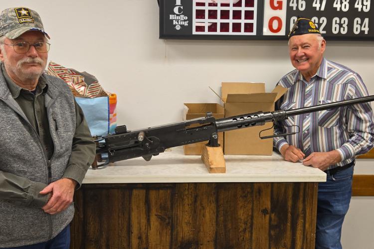 Mark Wiechmann with the M2 HB Browning 50 caliber machine gun metal replica with Clayton Rados.