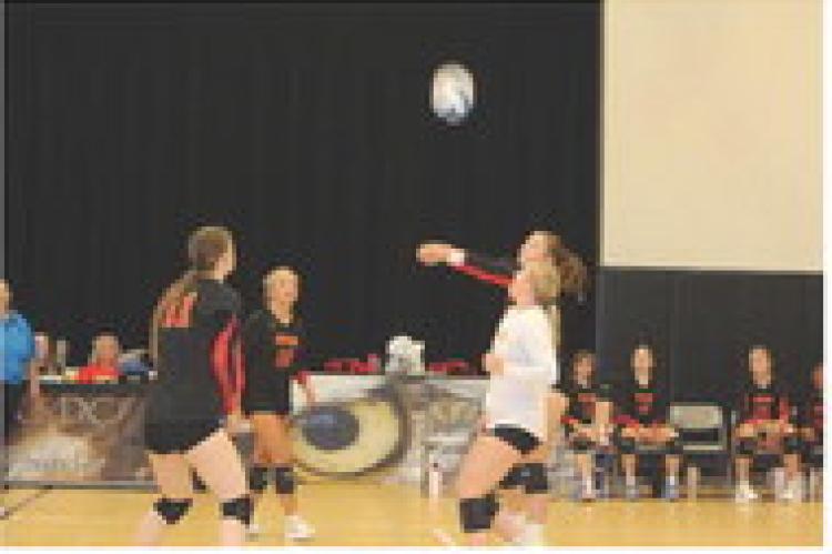 Breanna Hento, Brielle Voigt, and Jordyn Voigt get ready to assist Alexis Vanderlei.
