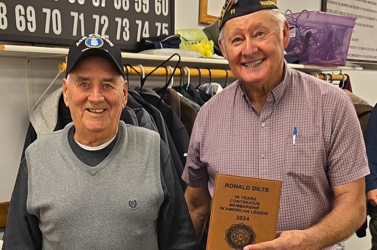 Ronald Dilts being presented with his plaque by Wagner American Legion Commander, Clayton Rados.
