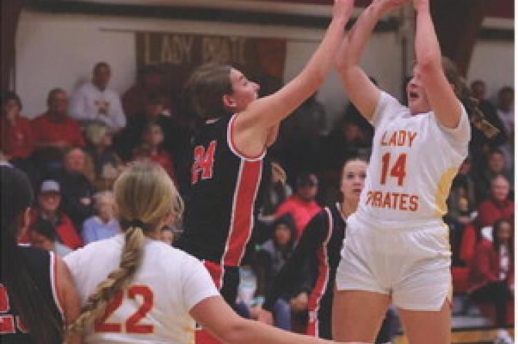Alexis Vanderlei gets over the tough defense for the 2-point attempt as Kaeli Wallinga sets up to rebound. Photos by Barb Pechous