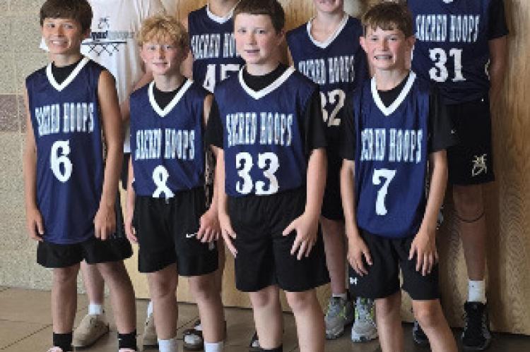 12U Sacred Hoops players pictured are back row, from left: Coach Trevin Price (Mount Marty University basketball player), Noah Kampshoff, Mason Tjeerdsma (Wagner), Houston Paxton. Front, from left: Clayton Hiles, Brody Thompson, Dawson Peters (Wagner), Tu
