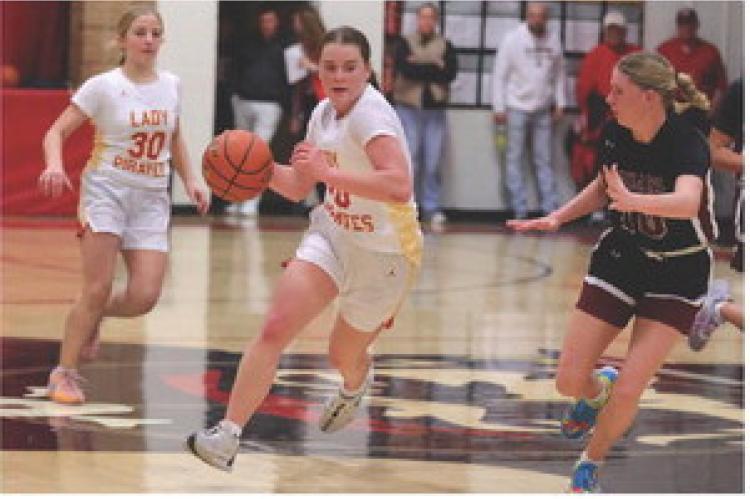Rilyn Thury takes the ball down the court to add 2 points to the scoreboard. Photo by Barb Pechous