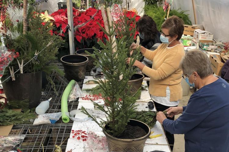 HOLIDAY WREATHS AND POTS BEING CREATED AT THE FLOWER SHOP