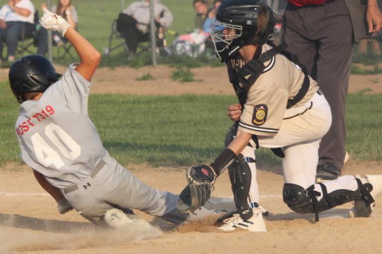 Cooper Kuhlman slides into home plate to score for the Wagner Teener 14U team in play action last Wednesday night in Wagner.