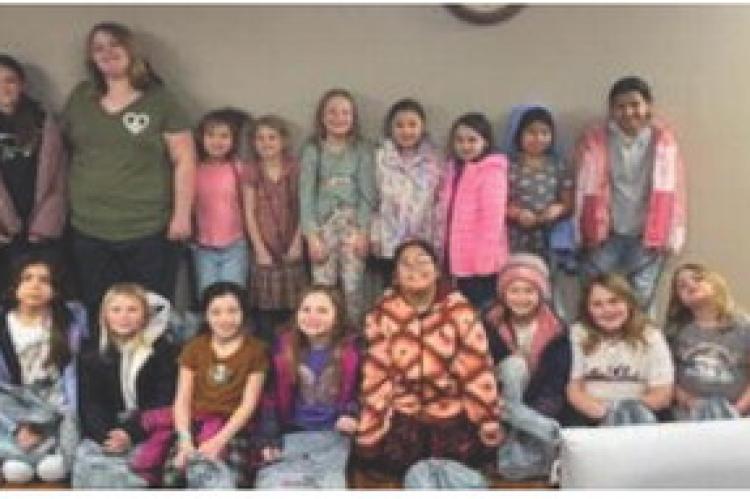GIRL SCOUTS EARN THEIR FIRST AID BADGE