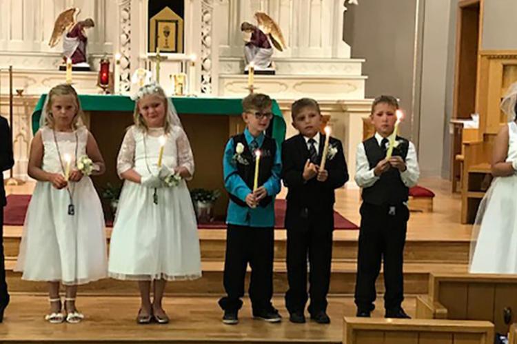 ST. JOHN'S CATHOLIC CHURCH CELEBRATES FIRST COMMUNION