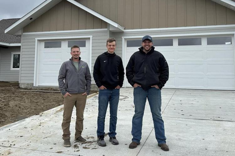 Pictured are, from left: Matt Lehman, Lucas Byler and Alex Waldner, in front of their current building project in Lake Andes.