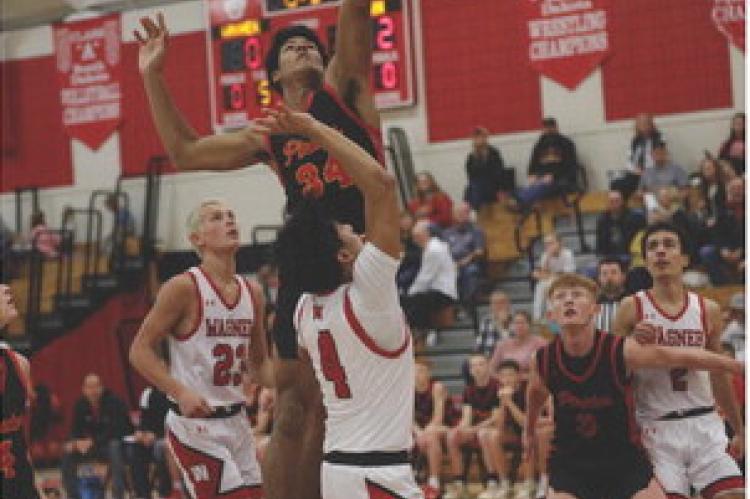 Al'Shamon Gunter goes up for the 2-point shot as Cale Cooper sets up to rebound.