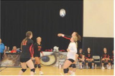 Breanna Hento, Brielle Voigt, and Jordyn Voigt get ready to assist Alexis Vanderlei.
