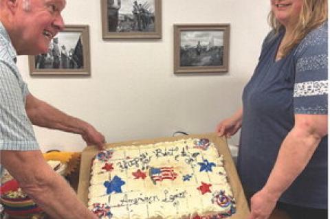 American Legion Auxiliary President Alyssa Mathis presenting the birthday cake to Post Commander Clayton Rados at the monthly American Legion and Auxiliary supper and meeting. Courtesy Photo
