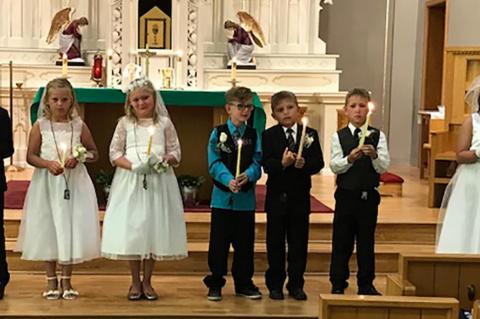 ST. JOHN'S CATHOLIC CHURCH CELEBRATES FIRST COMMUNION