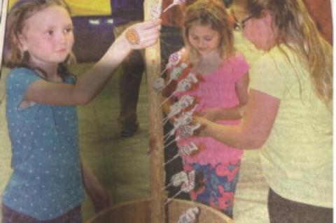 April 27, 2016 Avon Clarion - Ella Hamilton, Abby Gretschmann and Kate Swier pick from the Lollipop Stand at Friday nights Lions Club Fun Fest.