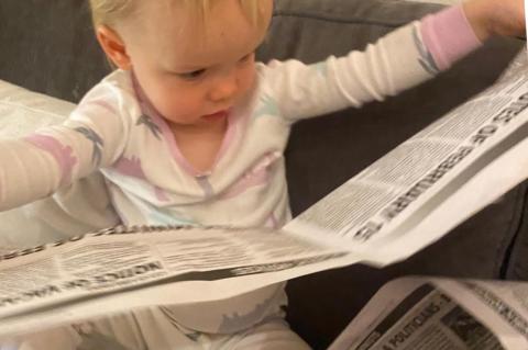 GRANDAUGHTER OF FORMER OWNER OF THE WAVE ENJOYING READING HER PAPER