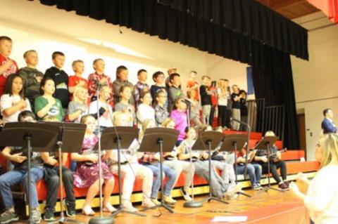 THIRD GRADE SINGS; FOURTH GRADE PLAYS UKULELES FOR NATIONAL ANTHEM