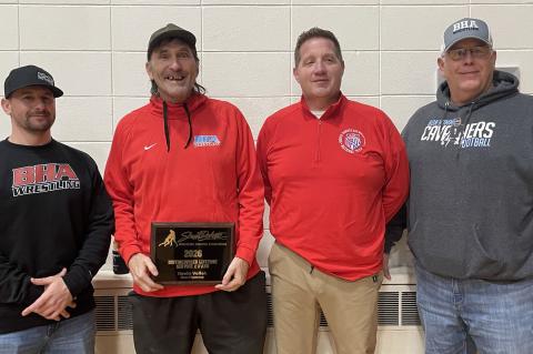 Kevin Vellek is presented with the 2026 Distinguished Lifetime Service Award prior to Bon Homme-Avon wrestling dual with Parkston January 20. On hand for the presentation are from left, Darren Kriz, Bon Homme-Avon wrestling coach, Kevin Vellek; Chris Sayl