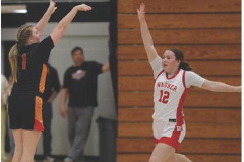 Jordyn Voigt with the 3-point attempt against a tough Wagner defense. Photography by Denelle