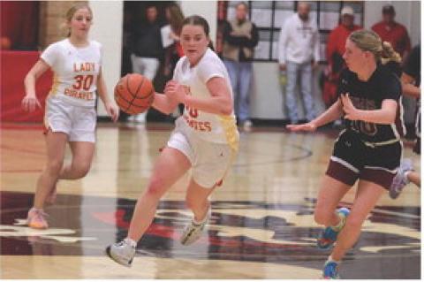 Rilyn Thury takes the ball down the court to add 2 points to the scoreboard. Photo by Barb Pechous