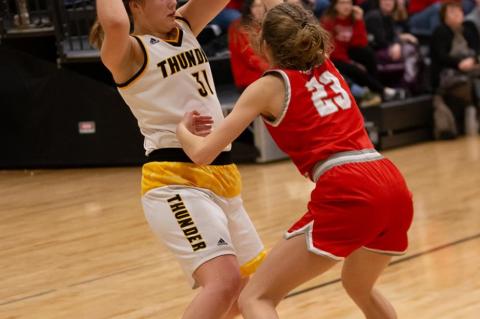 Mackenzie Muckey looks to pass the ball .