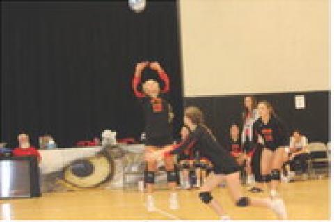 Kaydence Metzger keeps the ball in play. Brielle Voigt, Abby Gretschmann, and Alexis Vanderlei.
