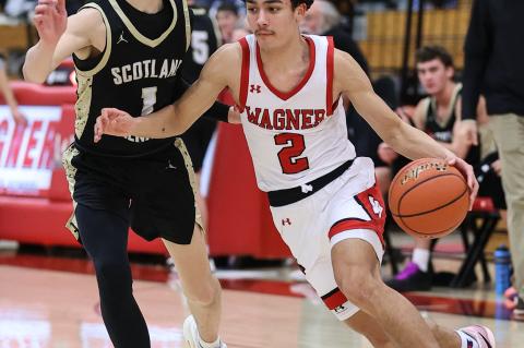 Jesse Zephier drives to the basket for the Red Raiders. Photos by Barb Pechous