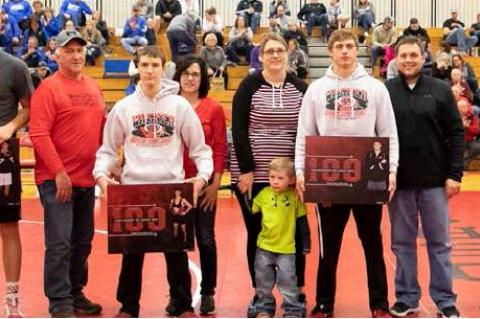 Wrestlers who ad attained 100+ wins in their career were also honored with their parents presenting their award. They are, from left: KJ St. Pierre (Kenny and Alta St. Pierre), Lance Soukup (Roger and Marjo Soukup), Preston Nedved (Lindsey Nedved and Ross