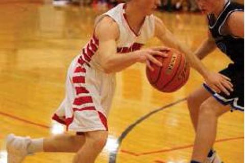 #10 Chris Nelson drives to the hoop  .