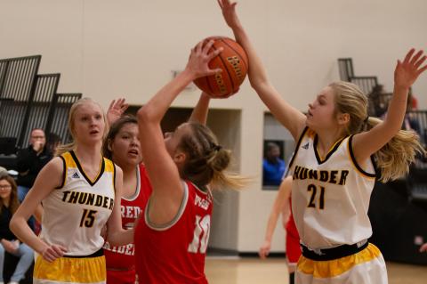 Josie Brouwer stops the shot attempt as Lexie VanderPol moves in to assist. Photos by Barb Pechous