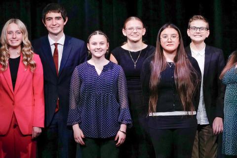 Pictured are the Wagner Oral Interp members with their coach Megan Fischer (right). Photography by Denelle