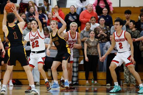 Leon Fields, Michael Koupal and Jesse Zephier on defense. Photos by Barb Pechous