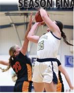 Brielle Voigt elevates to defend the basket with a block attempt.
