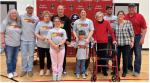 Family members present for the Coach Poppe's reception February 3rd were, back row, from left: Carole Foster, Nick Poppe, Shelly Poppe, Coach Poppe, Megan Heyden, Margaret Poppe, Brand Heyden, Brenda Fathke, and Mel Fathke; front row: Havorly Heyden, and 